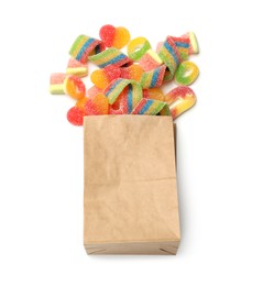 Paper bag with many different tasty candies isolated on white, top view