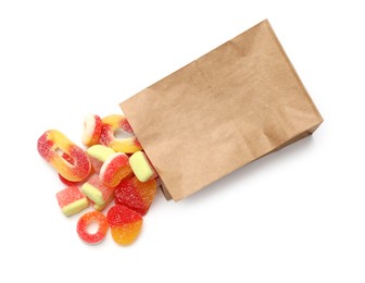 Photo of Paper bag with many different tasty candies isolated on white, top view