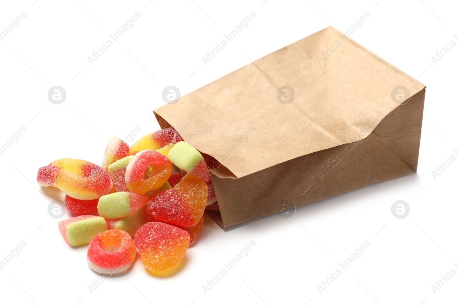 Photo of Paper bag with many different tasty candies isolated on white