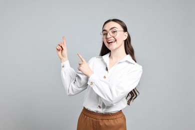 Happy businesswoman welcoming clients or partners on grey background