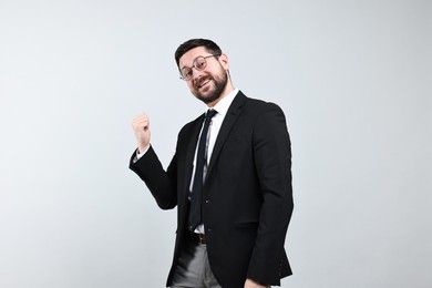 Photo of Happy businessman welcoming clients or partners on grey background