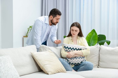 Photo of Man comforting his resentful girlfriend at home