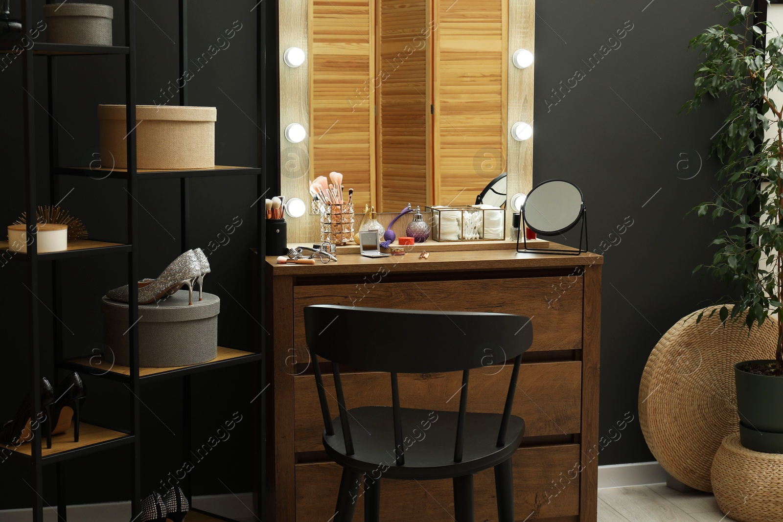 Photo of Makeup room. Mirrors, different beauty products, shoes, dresser and chair indoors