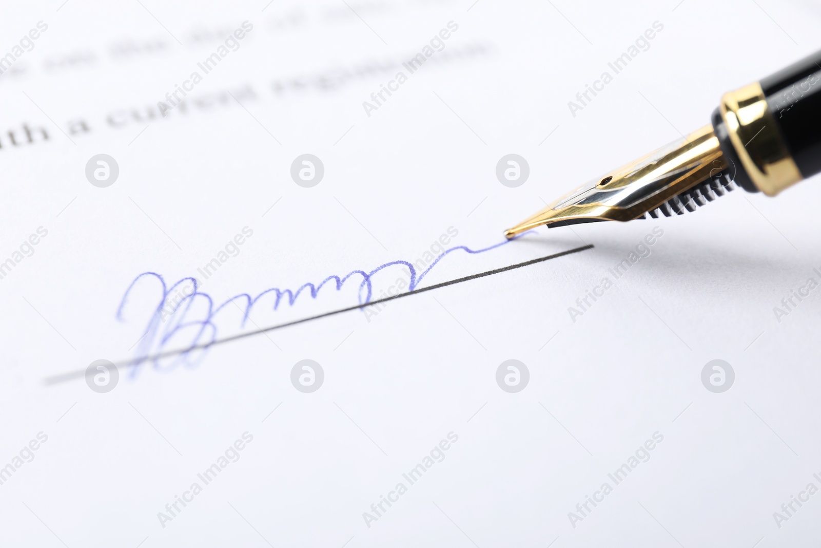 Photo of Fountain pen leaving signature on contract, closeup