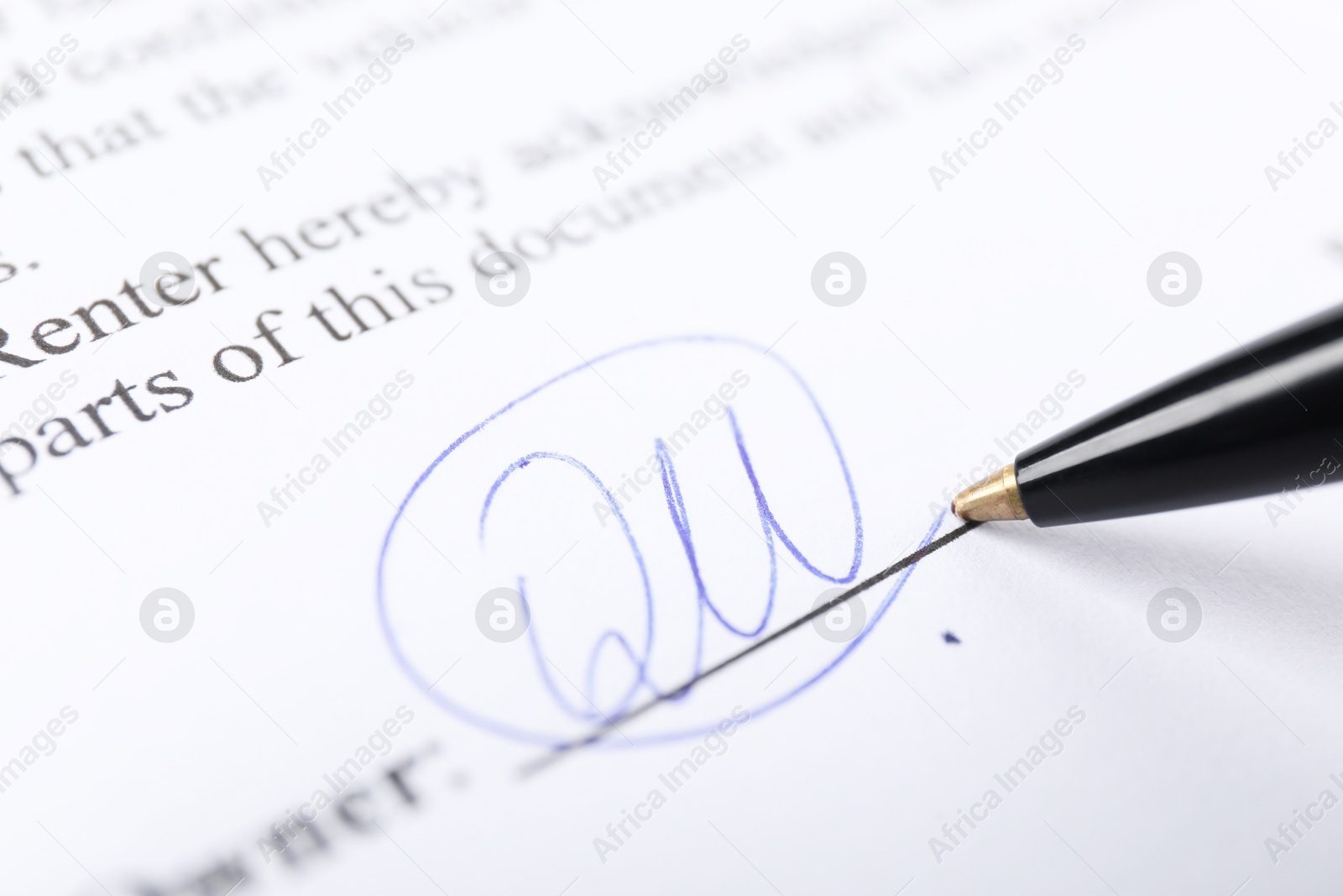 Photo of Pen leaving signature on contract, closeup view