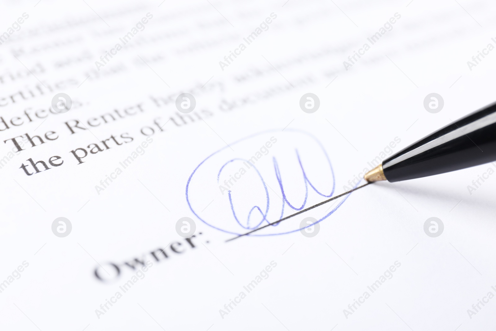 Photo of Pen leaving signature on contract, closeup view