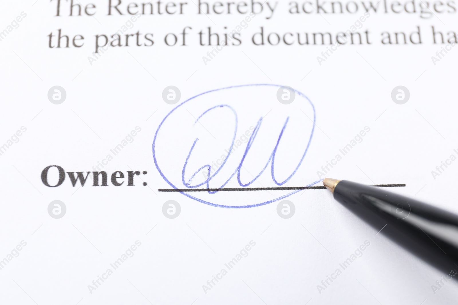 Photo of Pen leaving signature on contract, closeup view