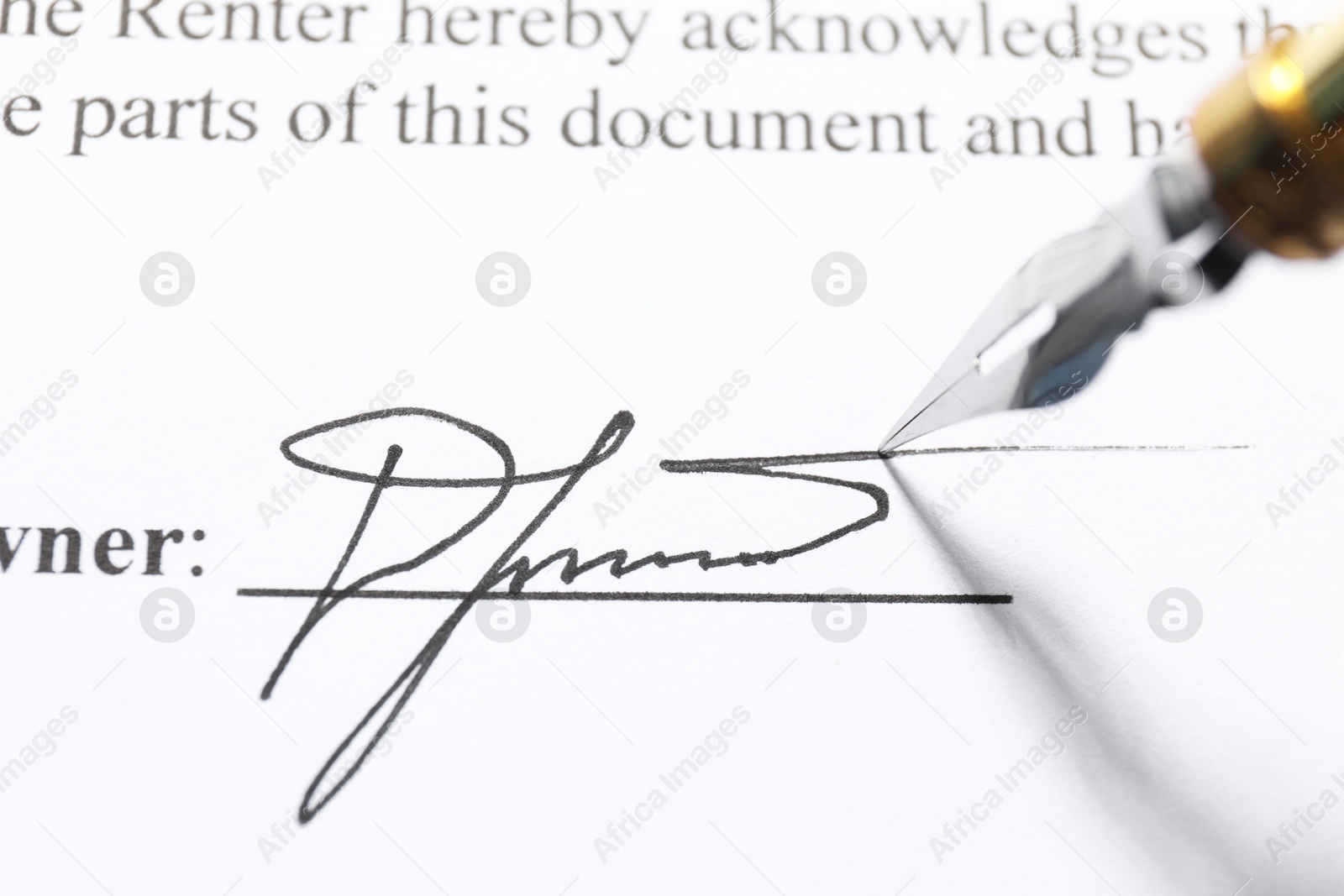 Photo of Fountain pen leaving signature on contract, closeup