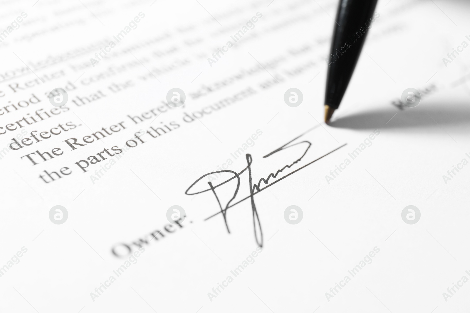 Photo of Pen leaving signature on contract, closeup view