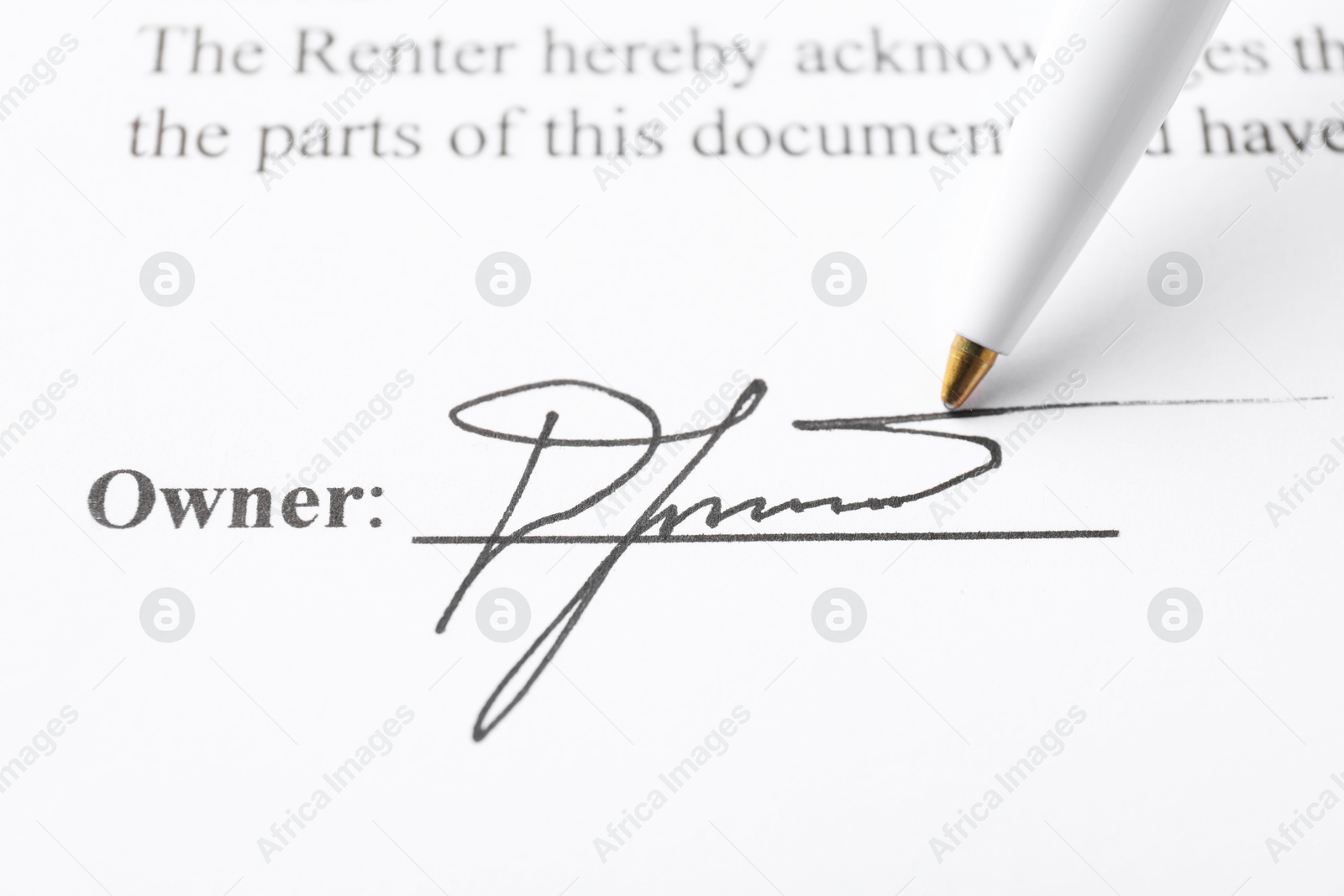 Photo of Signature and pen on paperwork, closeup view