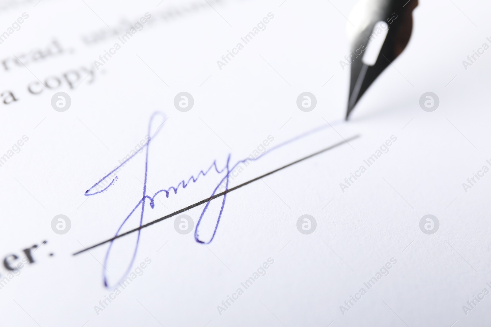 Photo of Fountain pen leaving signature on contract, closeup