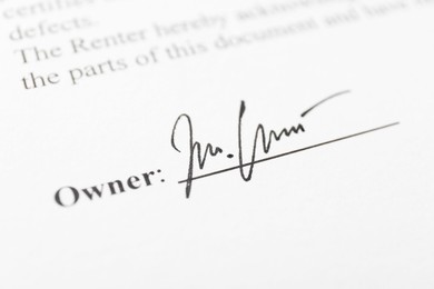 Photo of Owner's handwritten signature on paperwork, closeup view