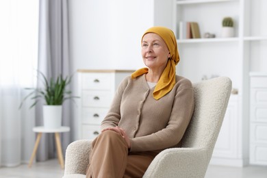 Photo of Senior woman with cancer on armchair at home