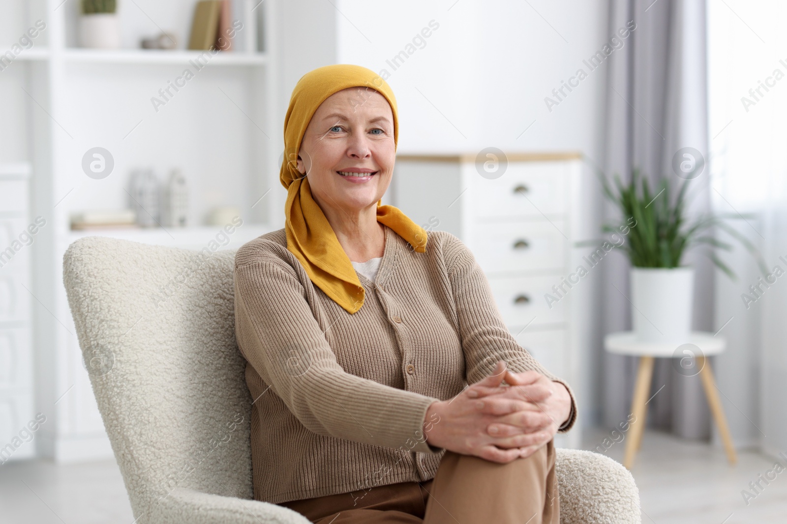 Photo of Senior woman with cancer on armchair at home