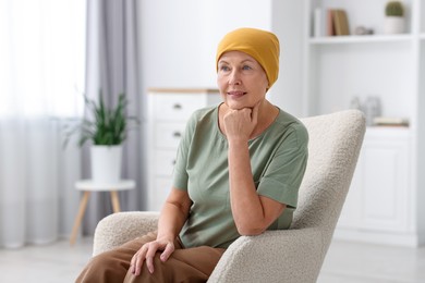 Photo of Senior woman with cancer on armchair at home