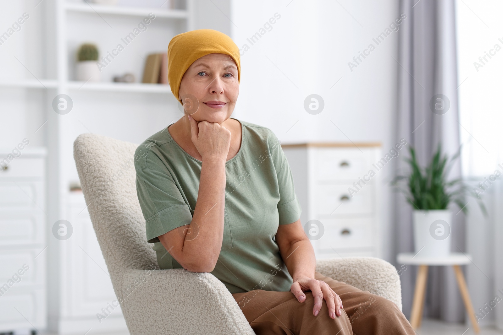 Photo of Senior woman with cancer on armchair at home