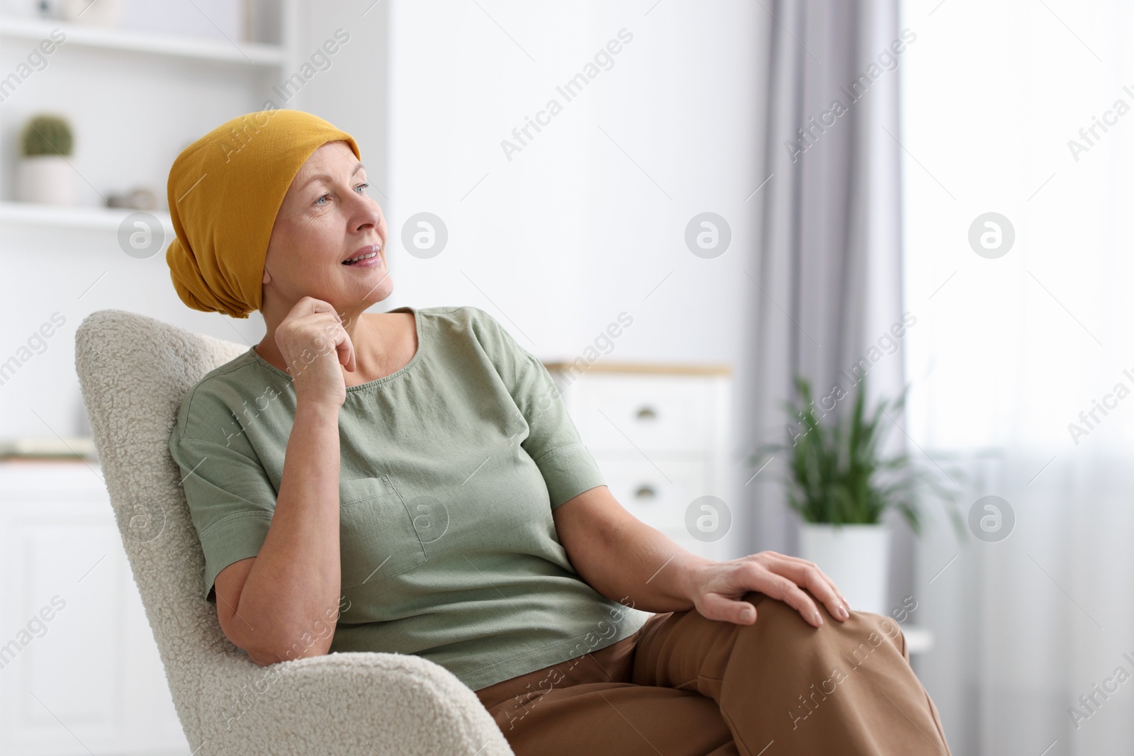 Photo of Senior woman with cancer on armchair at home