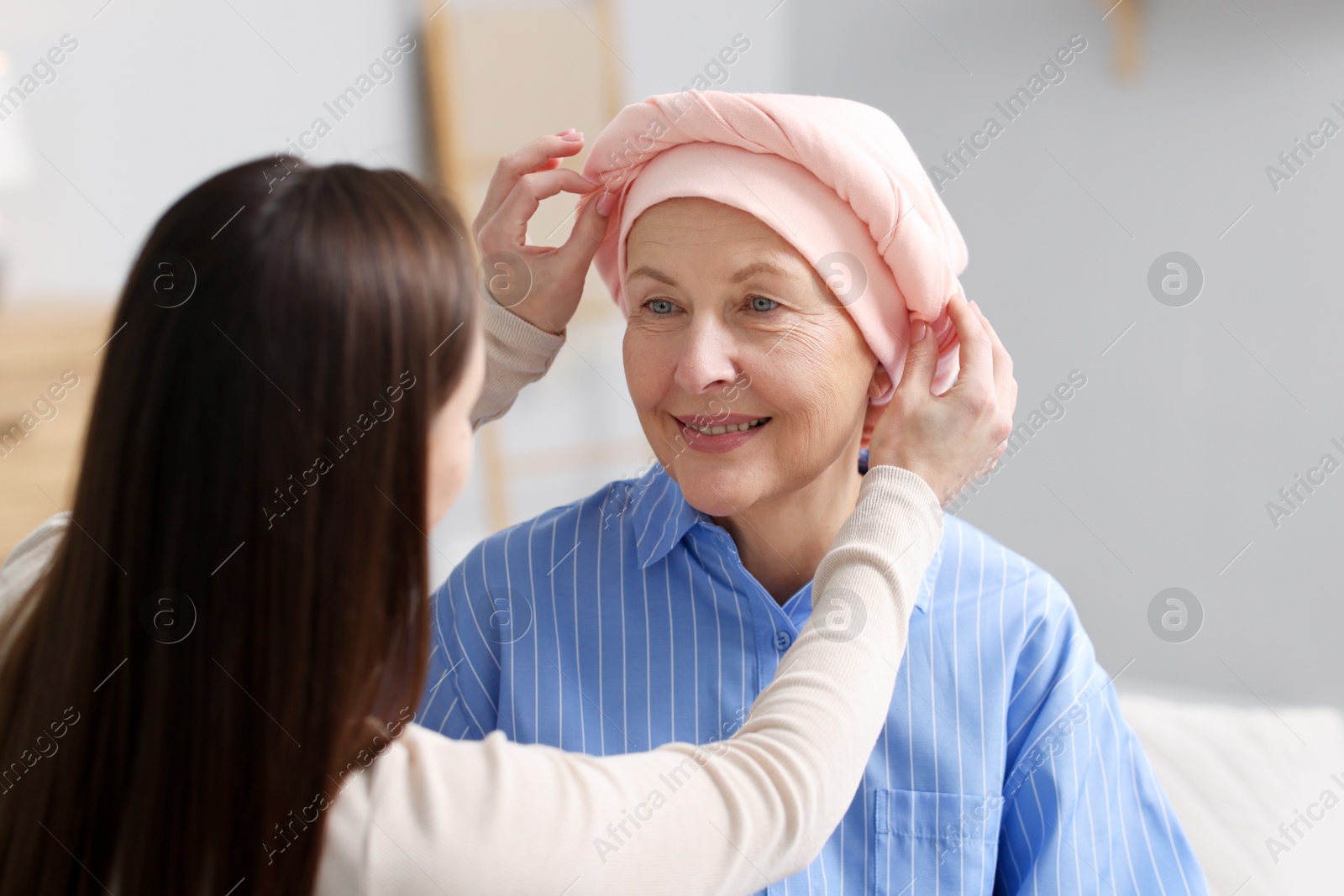 Photo of Caregiver helping woman with cancer at home