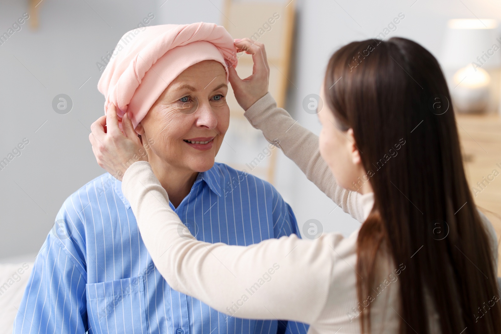 Photo of Caregiver helping woman with cancer at home