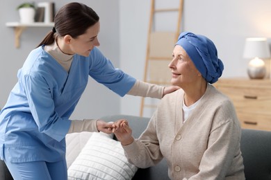 Photo of Nurse helping woman with cancer at home