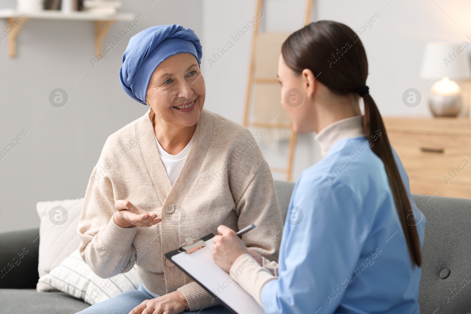 Photo of Woman with cancer and nurse at home