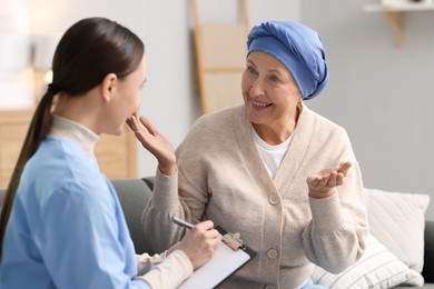 Photo of Woman with cancer and nurse at home