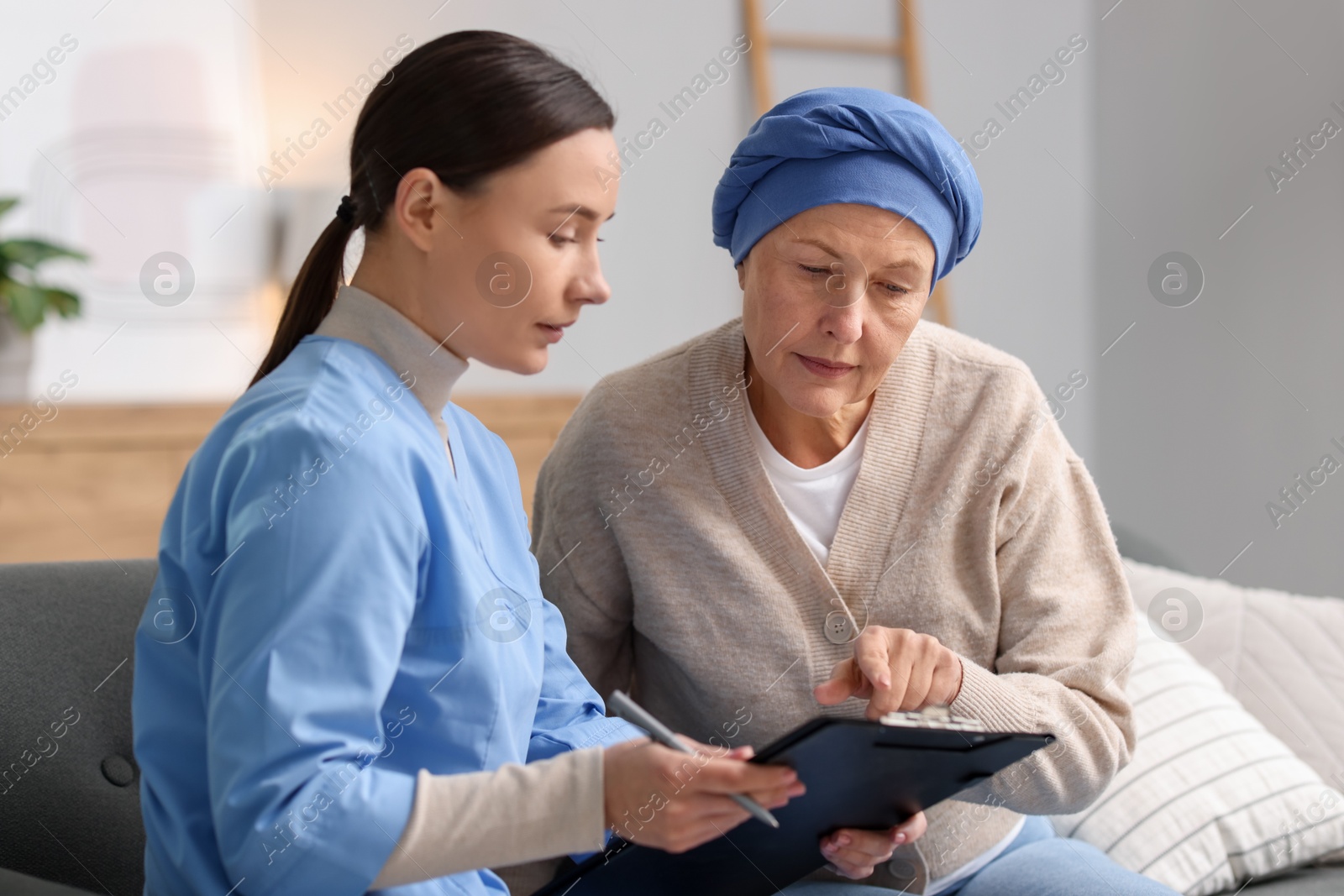 Photo of Woman with cancer and nurse at home