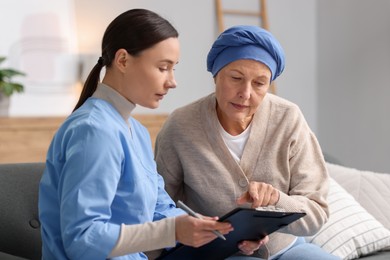 Photo of Woman with cancer and nurse at home