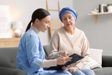 Photo of Woman with cancer and nurse at home