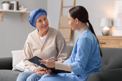 Photo of Woman with cancer and nurse at home