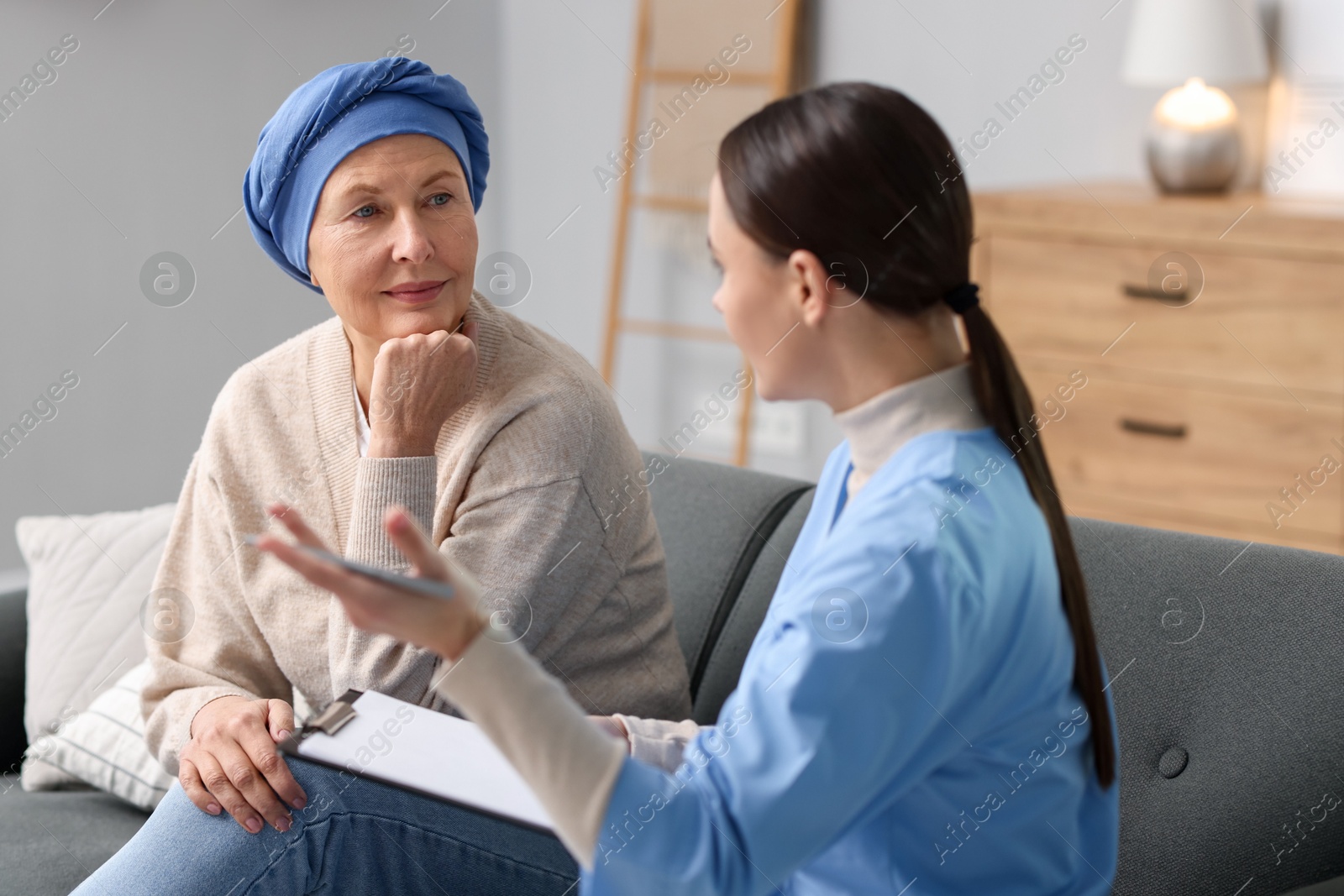 Photo of Woman with cancer and nurse at home