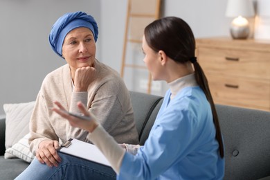 Photo of Woman with cancer and nurse at home