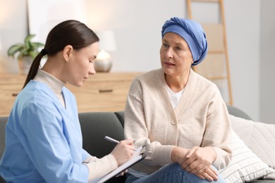 Photo of Woman with cancer and nurse at home