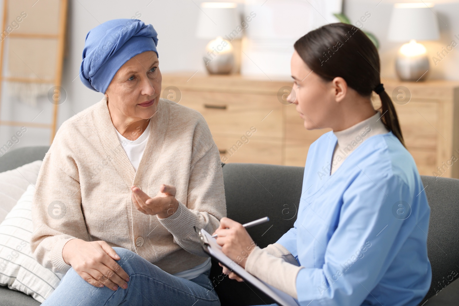 Photo of Woman with cancer and nurse at home