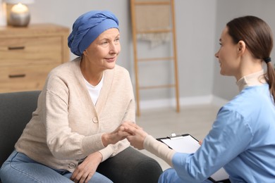 Nurse supporting woman with cancer at home