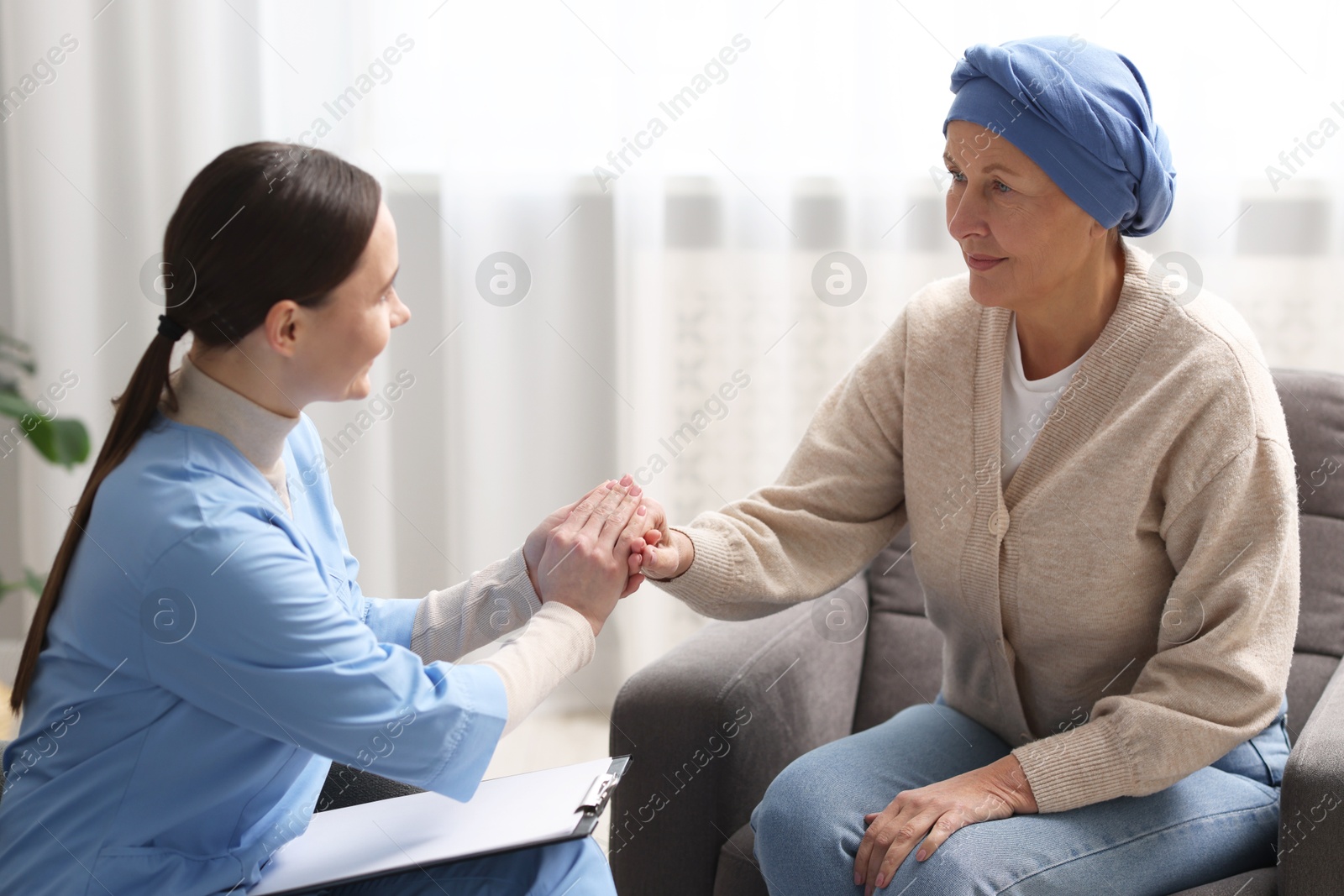 Photo of Nurse supporting woman with cancer at home