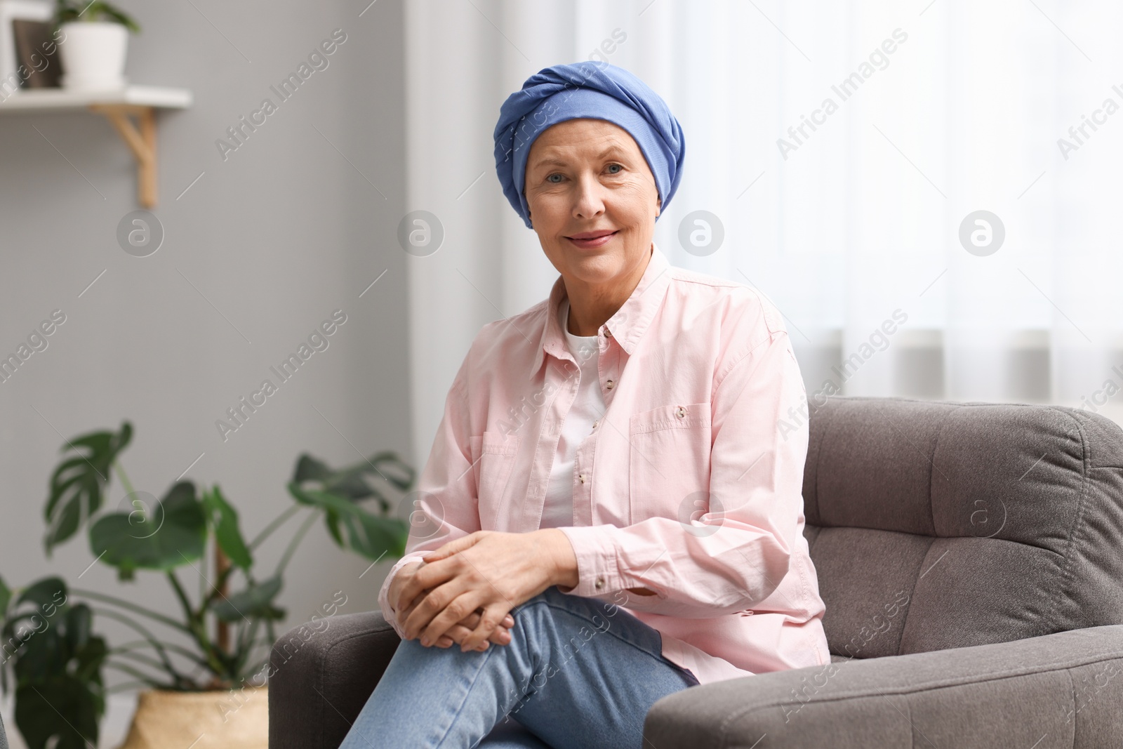 Photo of Senior woman with cancer on armchair at home