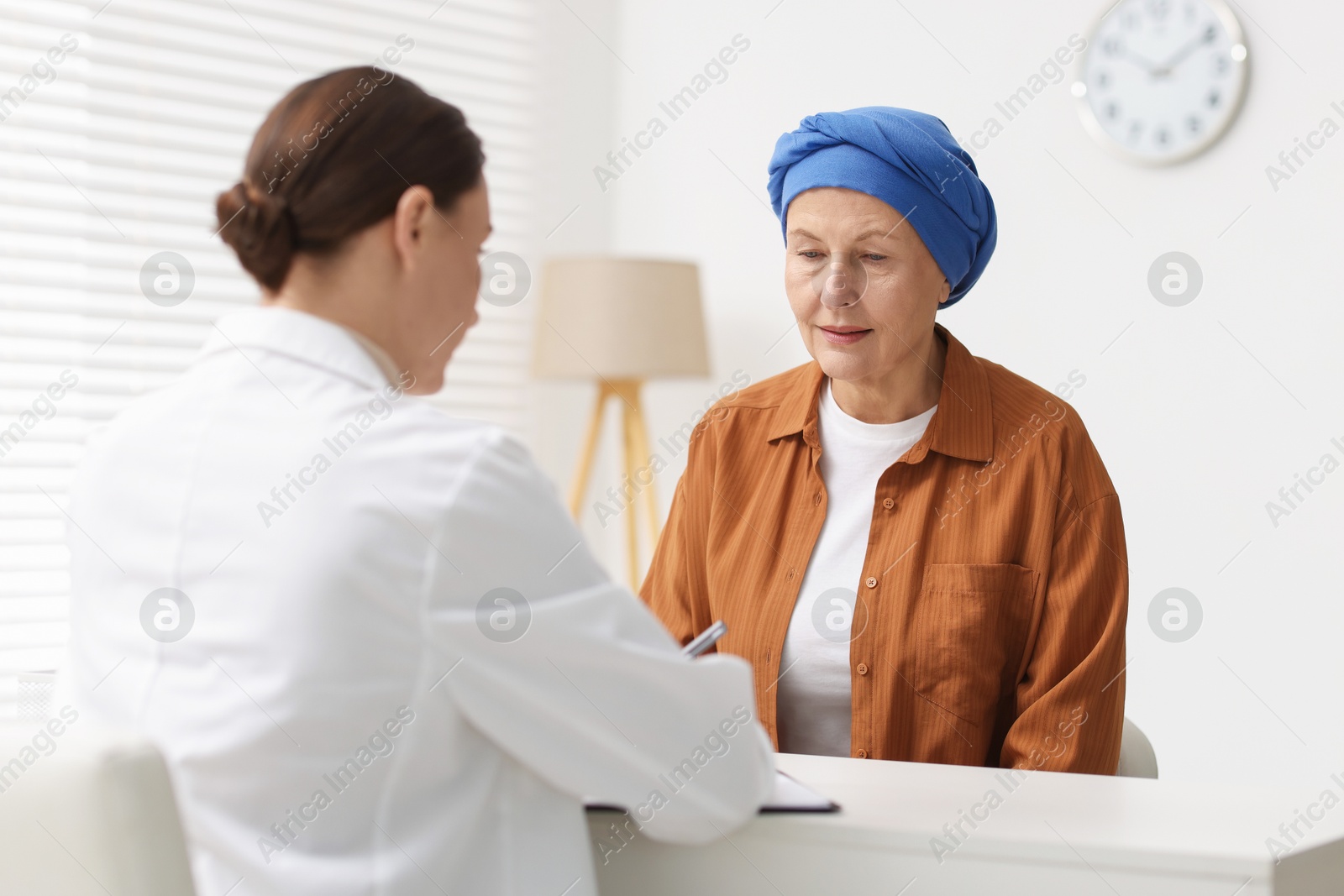 Photo of Senior woman with cancer visiting oncologist in clinic