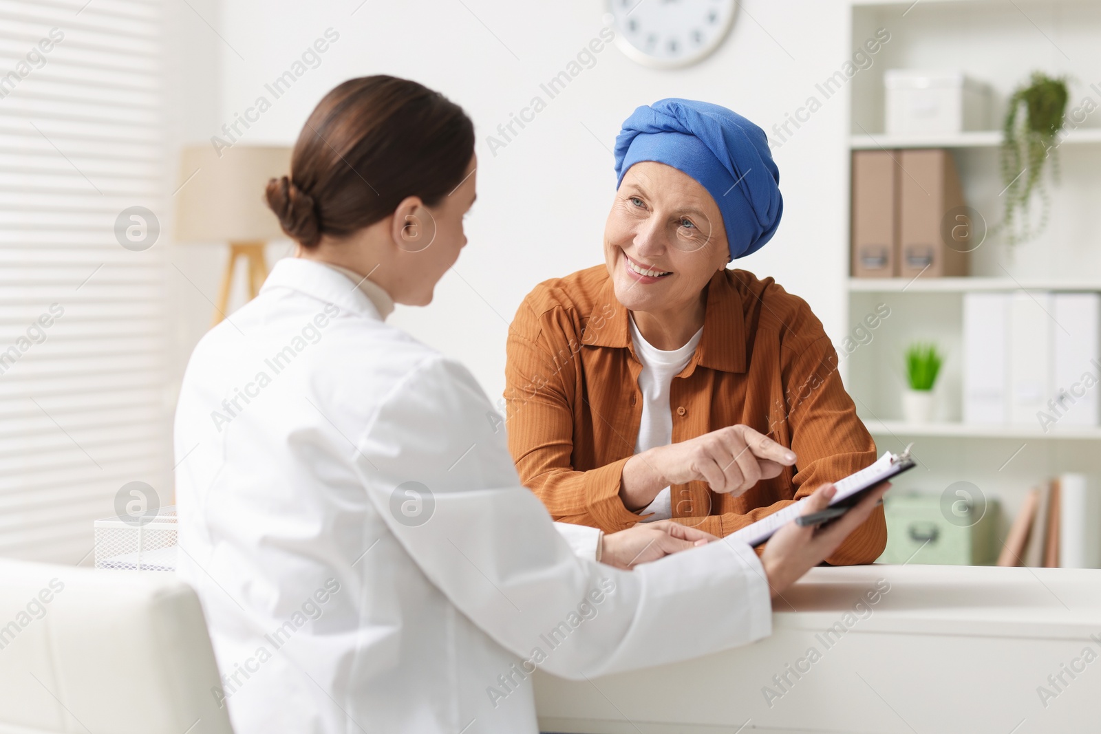 Photo of Senior woman with cancer visiting oncologist in clinic