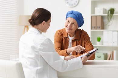 Photo of Senior woman with cancer visiting oncologist in clinic