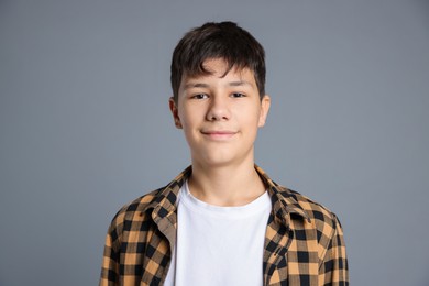 Photo of Portrait of teenage boy on grey background