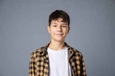 Photo of Portrait of teenage boy on grey background