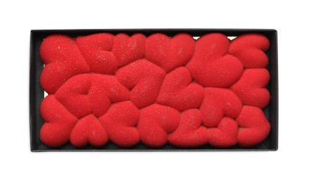 Chocolate bar decorated with hearts in box isolated on white, top view