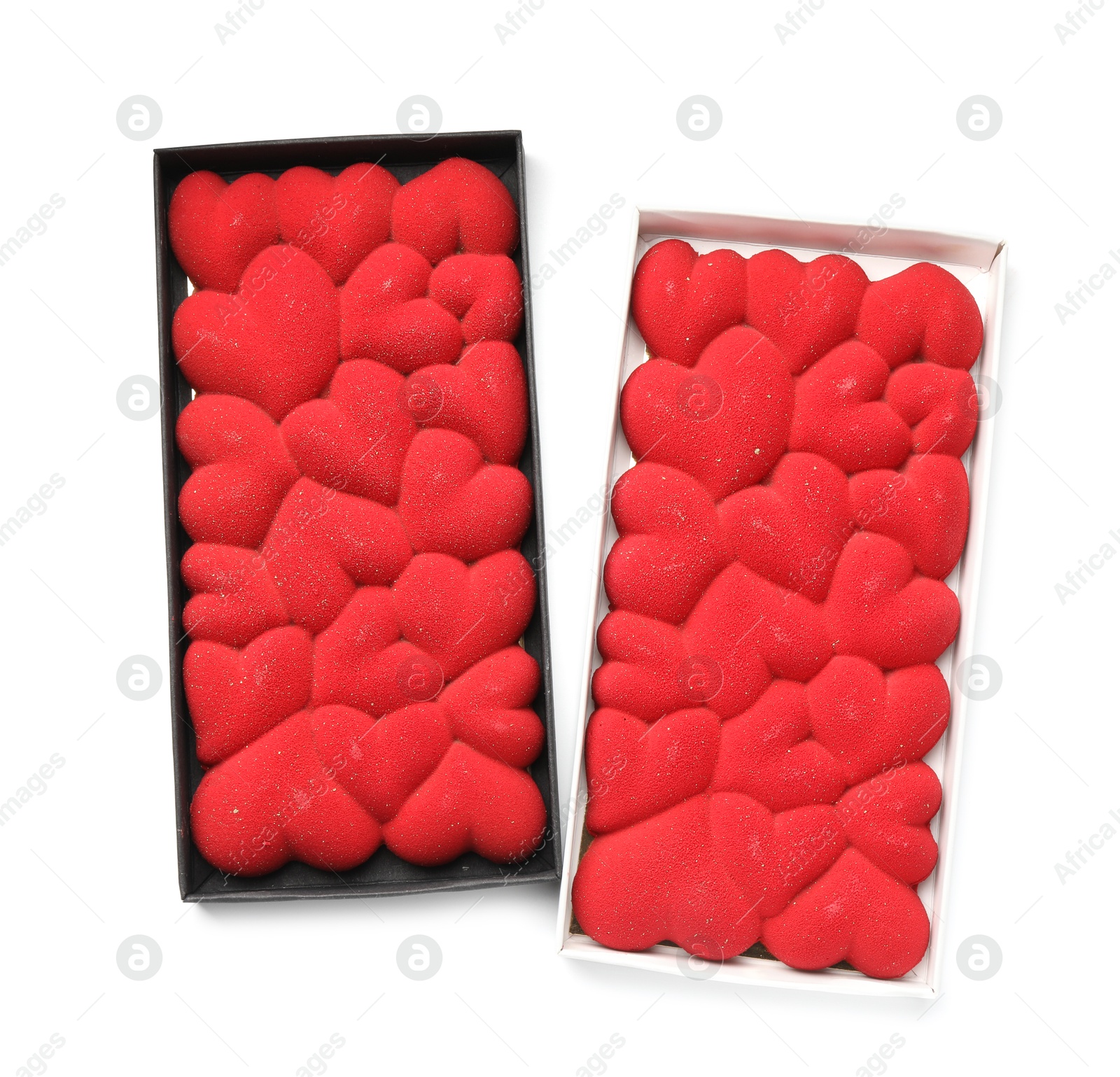 Photo of Chocolate bars decorated with hearts in boxes isolated on white, top view