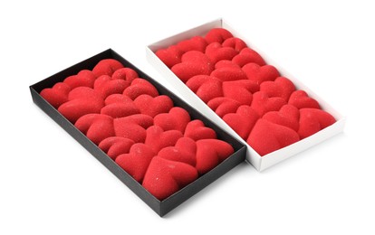 Photo of Chocolate bars decorated with hearts in boxes isolated on white