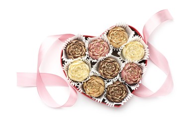 Flower shaped chocolate bonbons in box and pink ribbon isolated on white, top view