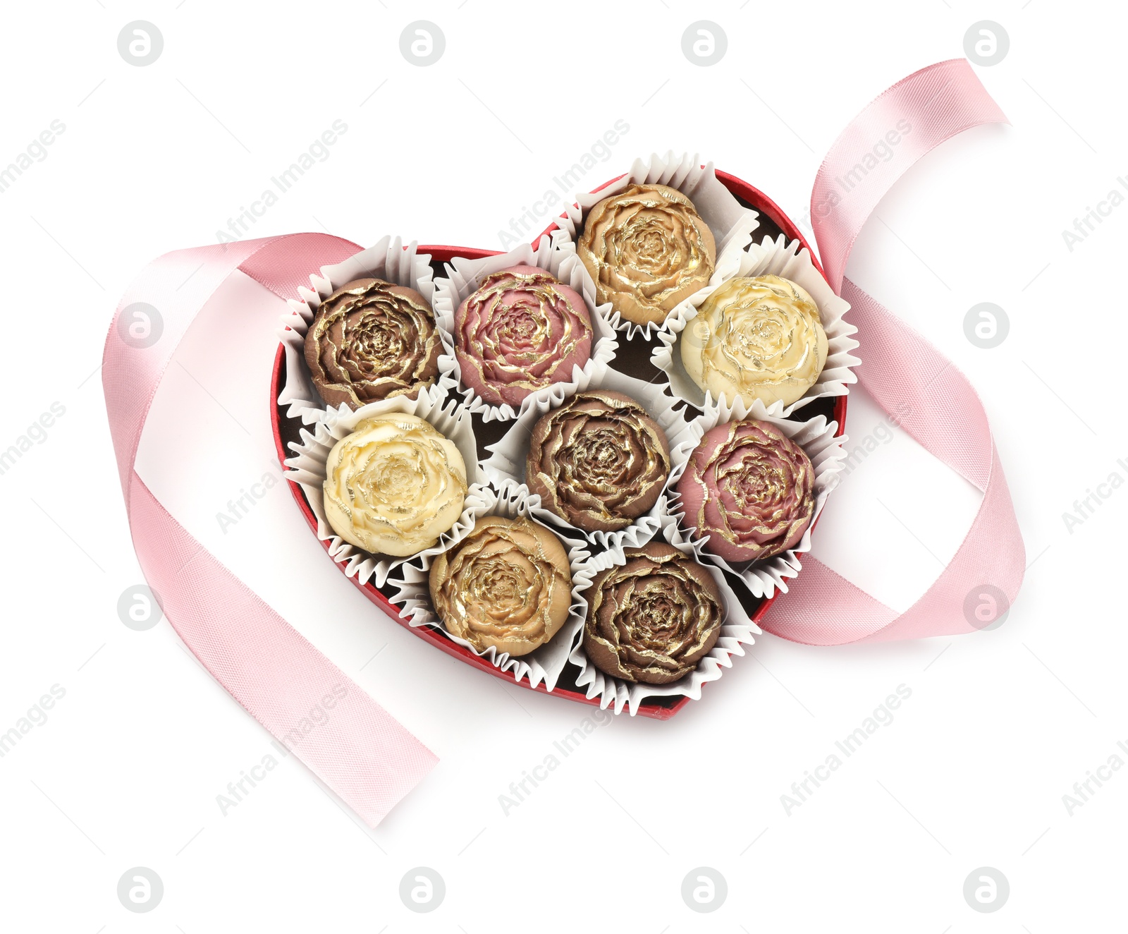 Photo of Flower shaped chocolate bonbons in box and pink ribbon isolated on white, top view