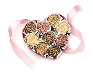 Flower shaped chocolate bonbons in box and pink ribbon isolated on white, top view