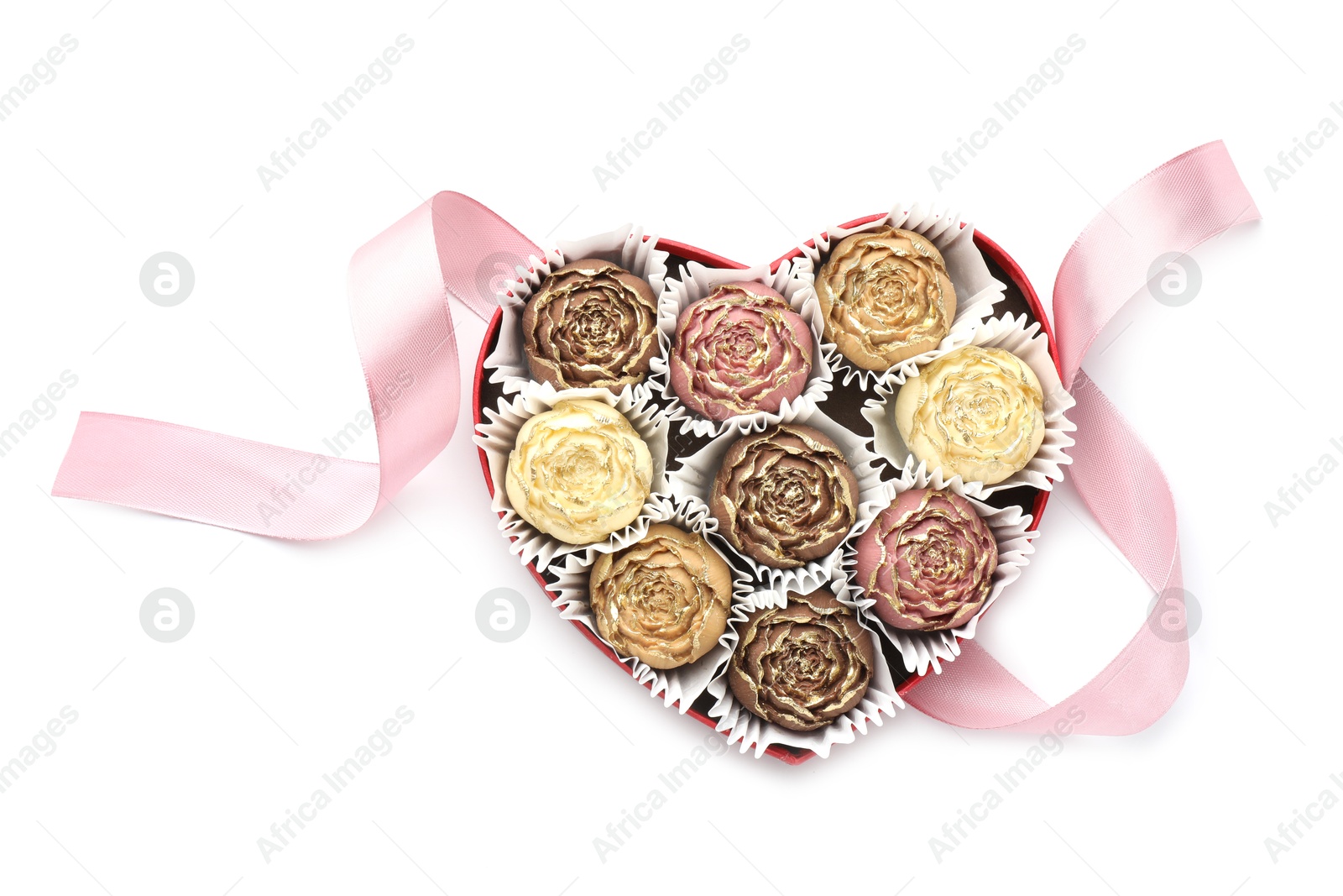 Photo of Flower shaped chocolate bonbons in box and pink ribbon isolated on white, top view