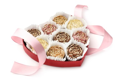 Photo of Flower shaped chocolate bonbons in box and pink ribbon isolated on white